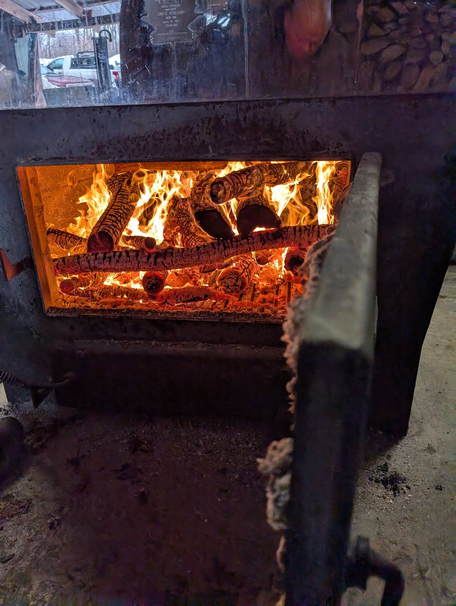 The wood fire roaring in the evaporator's open firebox
